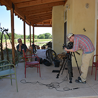 Documentary filmmaker Jacob Rosdail setting up for a shoot with Peter Russell and Sharman Apt Russell along the Gila River. Photo credits: Mary Harner